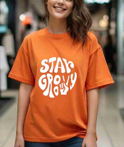 Stay Groovy Typography Printed Drop Shoulder Oversized T-Shirt for Women (Orange) – Trendy Half Sleeve Tee with Classic Round Neck, Soft & Breathable Cotton Blend Fabric for Comfort & Durability. Perfect for a Casual, Comfy, and Stylish Look!