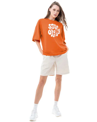 Stay Groovy Typography Printed Drop Shoulder Oversized T-Shirt for Women (Orange) – Trendy Half Sleeve Tee with Classic Round Neck, Soft & Breathable Cotton Blend Fabric for Comfort & Durability. Perfect for a Casual, Comfy, and Stylish Look!
